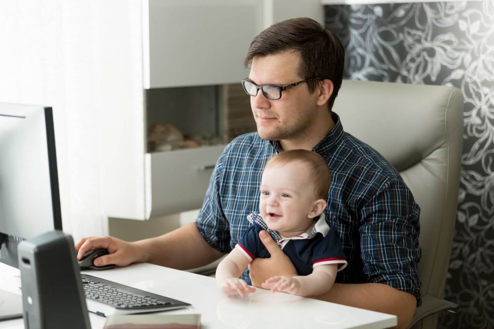 dad researching divorce with toddler in arms