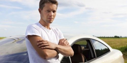 guy standing by car
