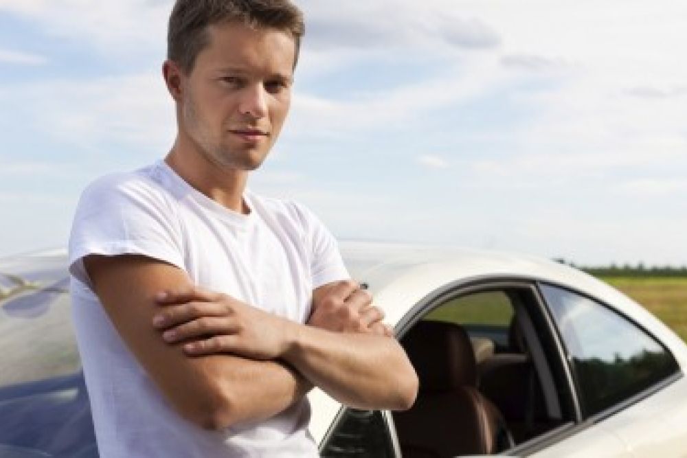 guy standing by car