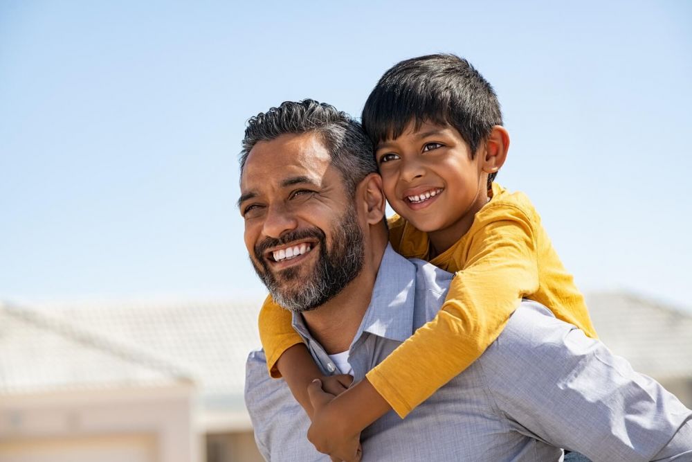 father with son on his shoulders