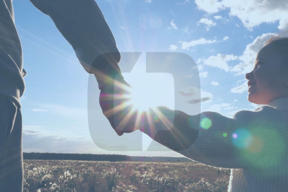 father holding hands with daughter outdoors with the cordell & cordell icon overlayed